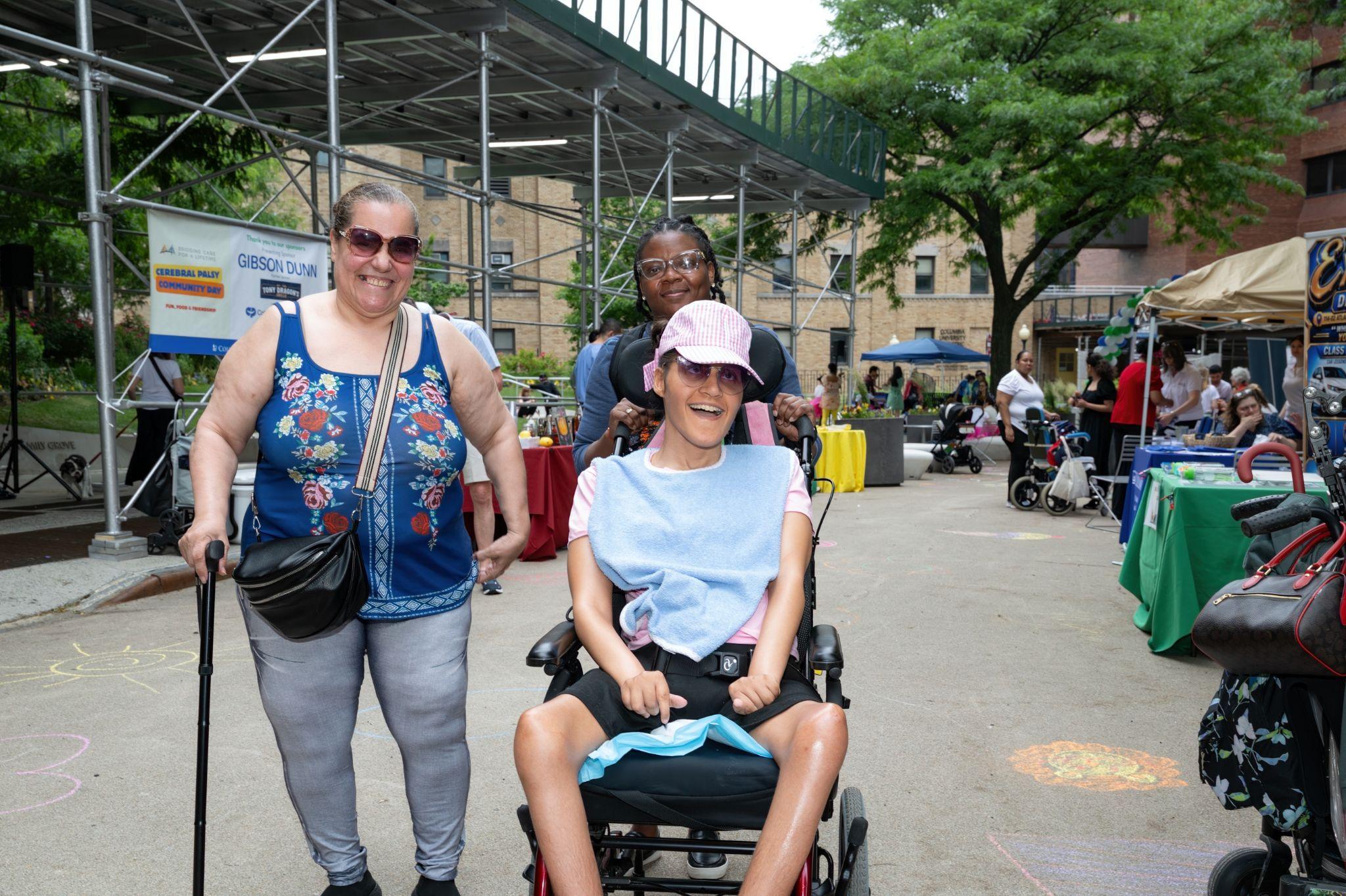 Three community members smiling together at CP Community Day